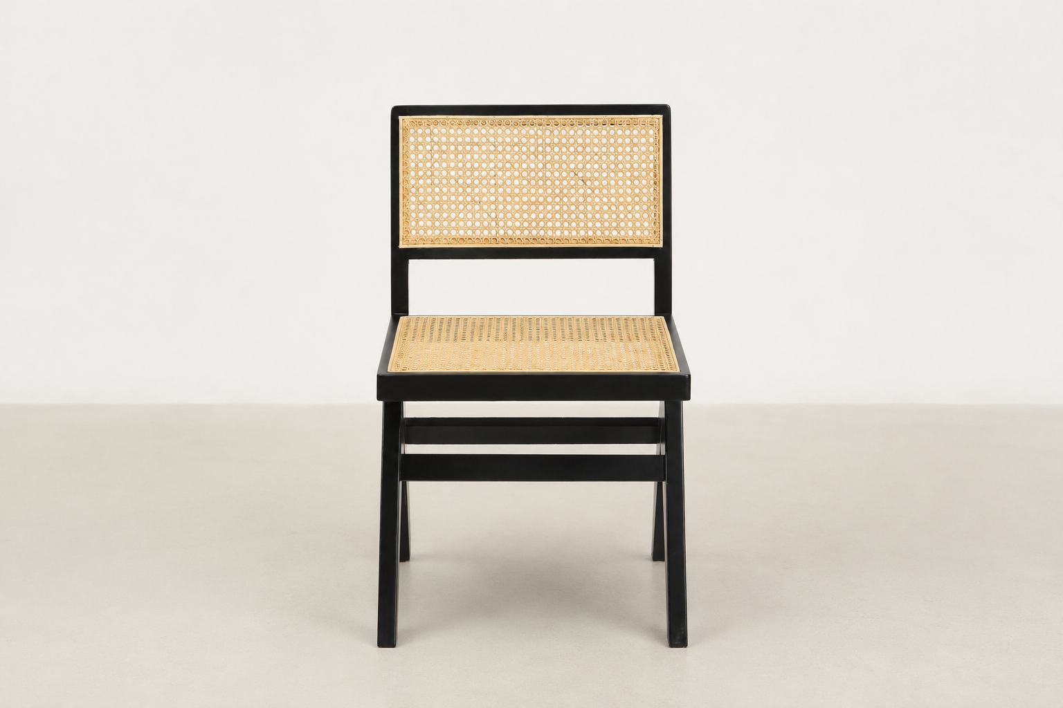 Baeloe Japandi dining chair with black wood frame and natural cane backrest