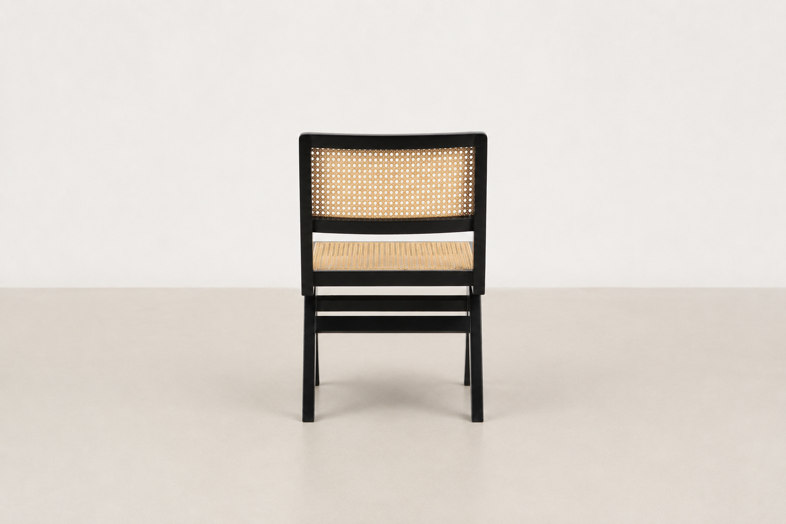 Baeloe Japandi dining chair with black wood frame and natural cane backrest