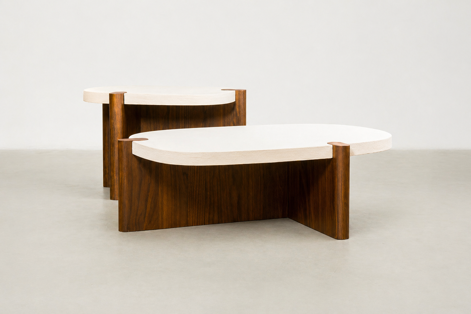 Nordli sculptural coffee table with walnut base and asymmetrical concrete-style top.