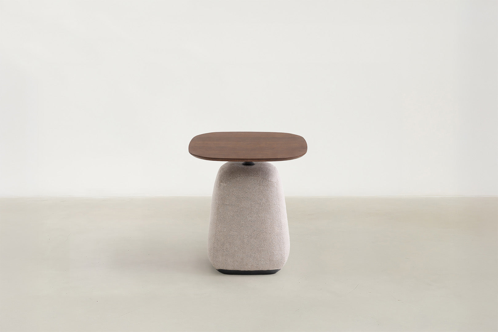 Esson end table with walnut veneer top and light grey upholstered base