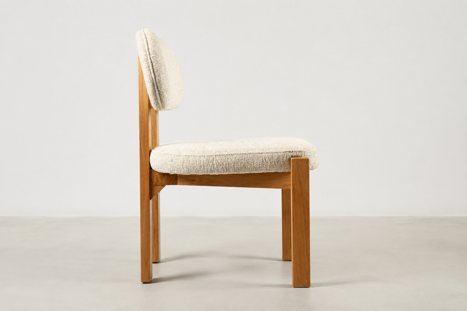 Sora Japandi dining chair with textured cream fabric and solid oak wood frame in natural stain