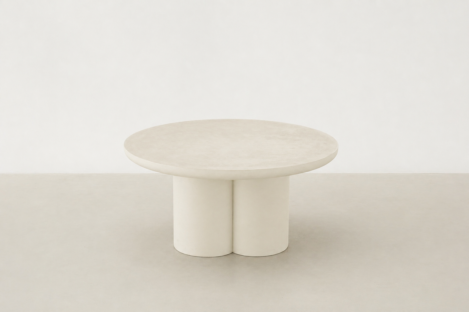 Pari Japandi coffee table with rounded silhouette and textured microcement finish