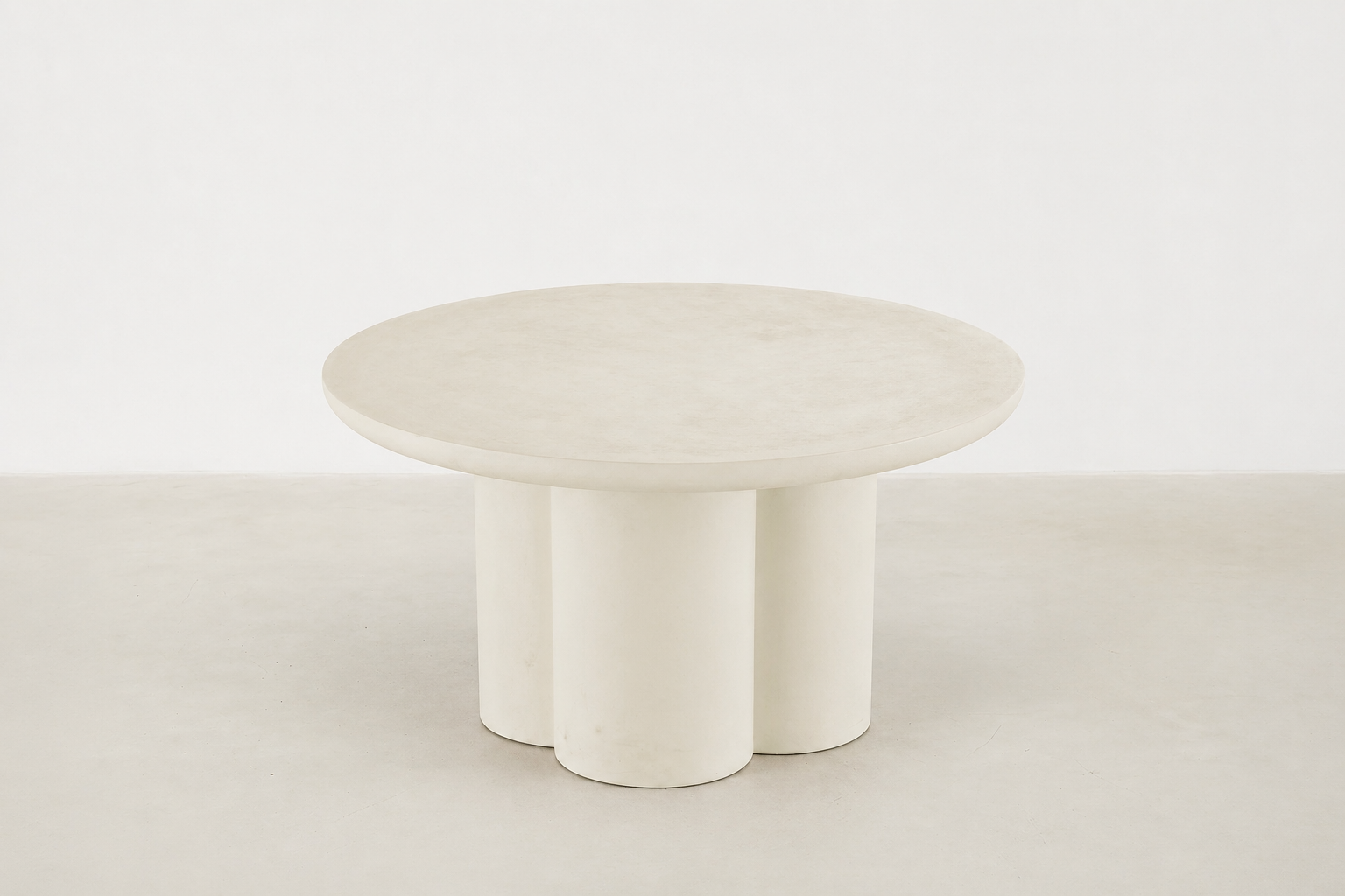 Pari Japandi coffee table with rounded silhouette and textured microcement finish
