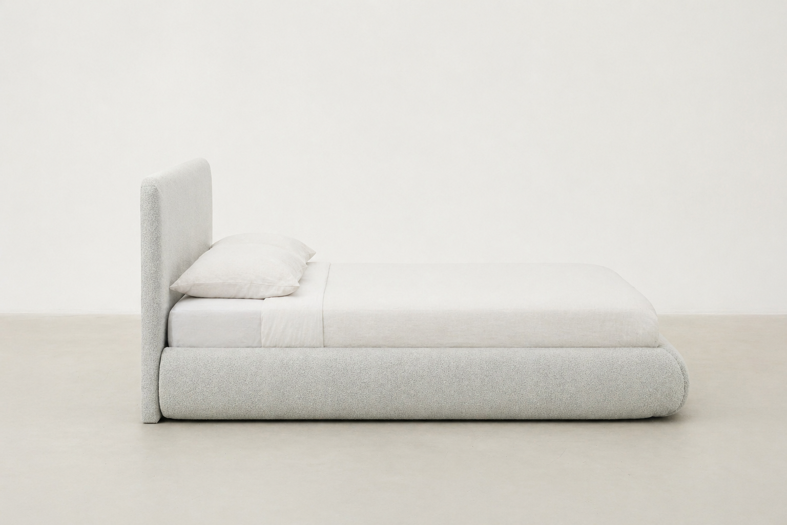 Sable light grey upholstered bed with rounded corners and low-profile design.