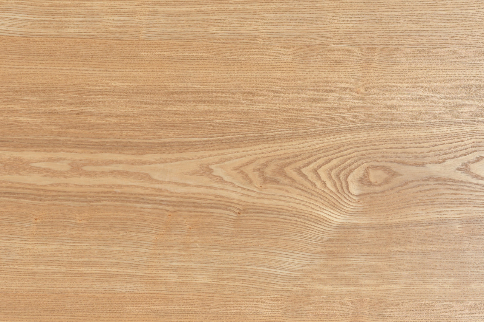 Side view of Zen Coffee Table showing its curved oak pedestal base and low-profile silhouette