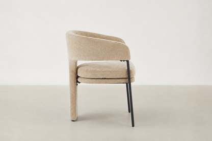 Aballo modern dining chair with upholstered rear leg detail and powder-coated steel frame