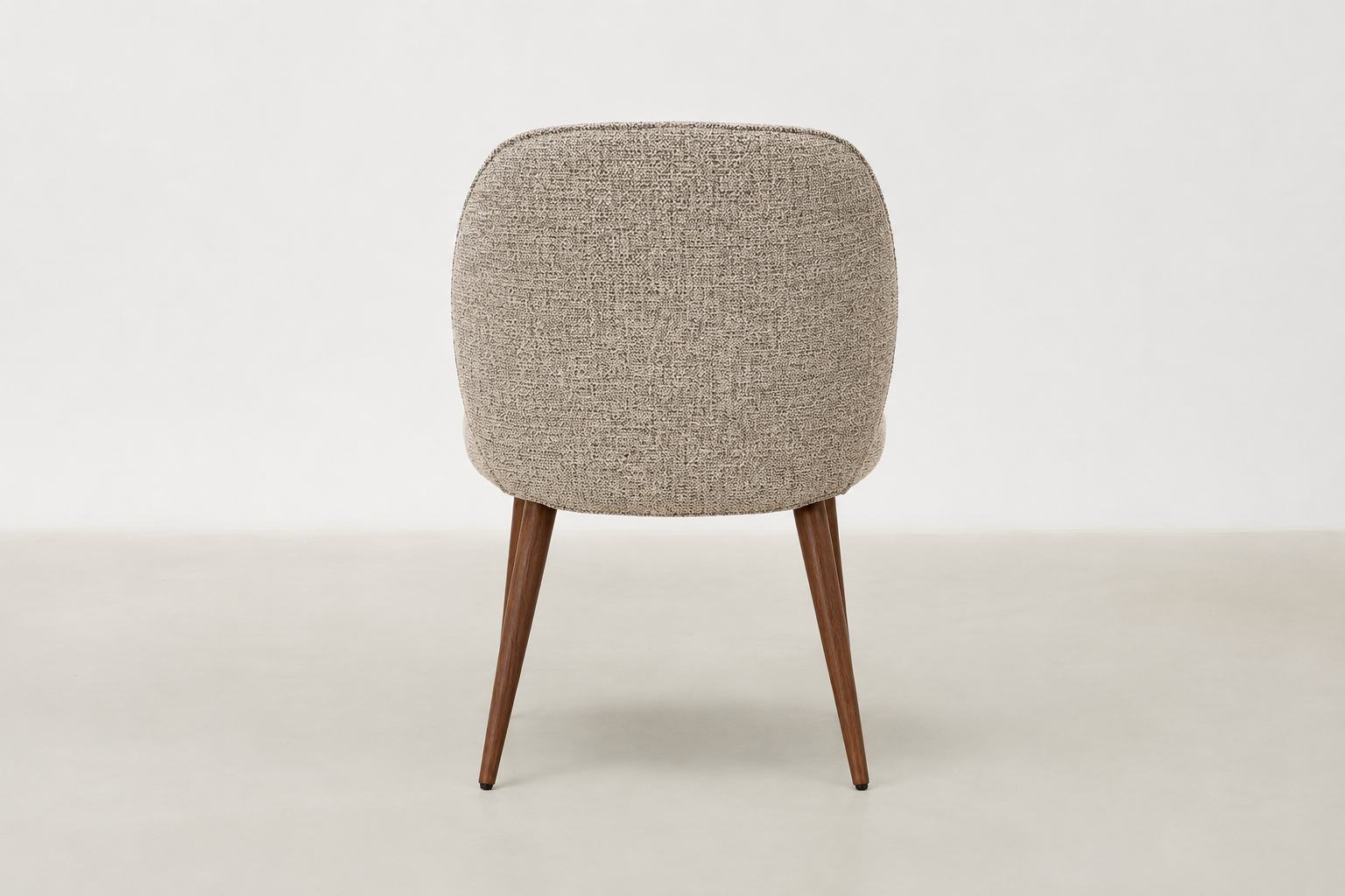Apua dining chair with textured polyester upholstery, scoop-back design, and walnut-finish steel legs