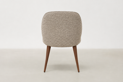 Apua dining chair with textured polyester upholstery, scoop-back design, and walnut-finish steel legs