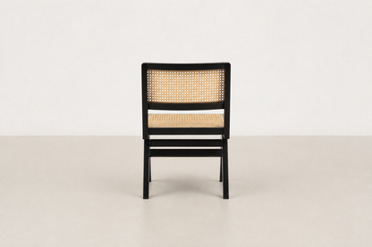 Baeloe Japandi dining chair with black wood frame and natural cane backrest