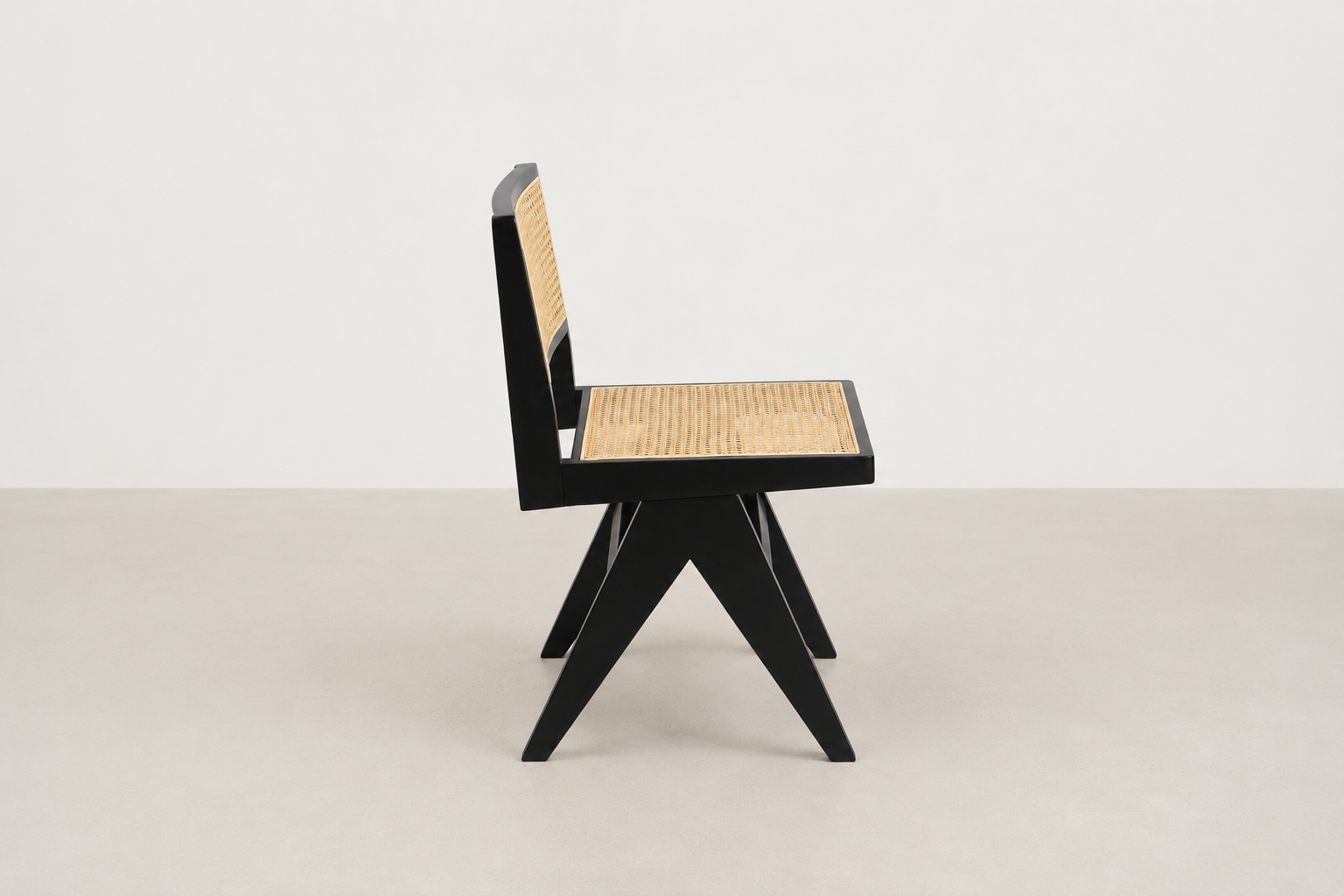 Baeloe Japandi dining chair with black wood frame and natural cane backrest