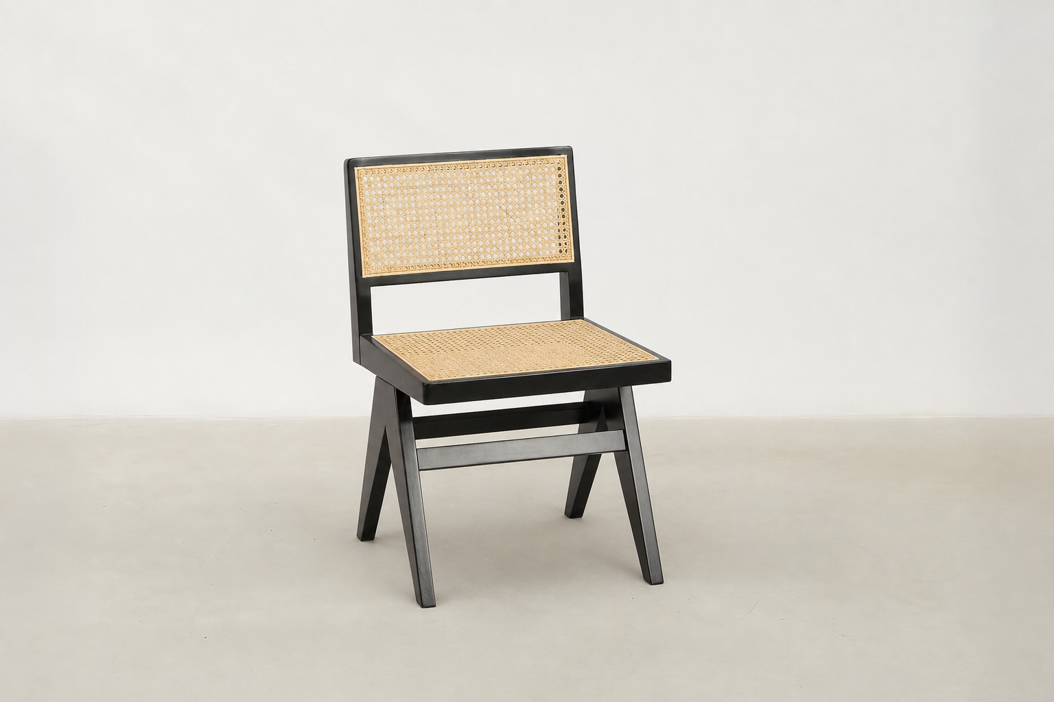 Baeloe Japandi dining chair with black wood frame and natural cane backrest