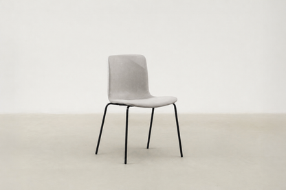 Minimalist dining chair with black metal legs and soft curved seat – Caprae chair for Canadian spaces