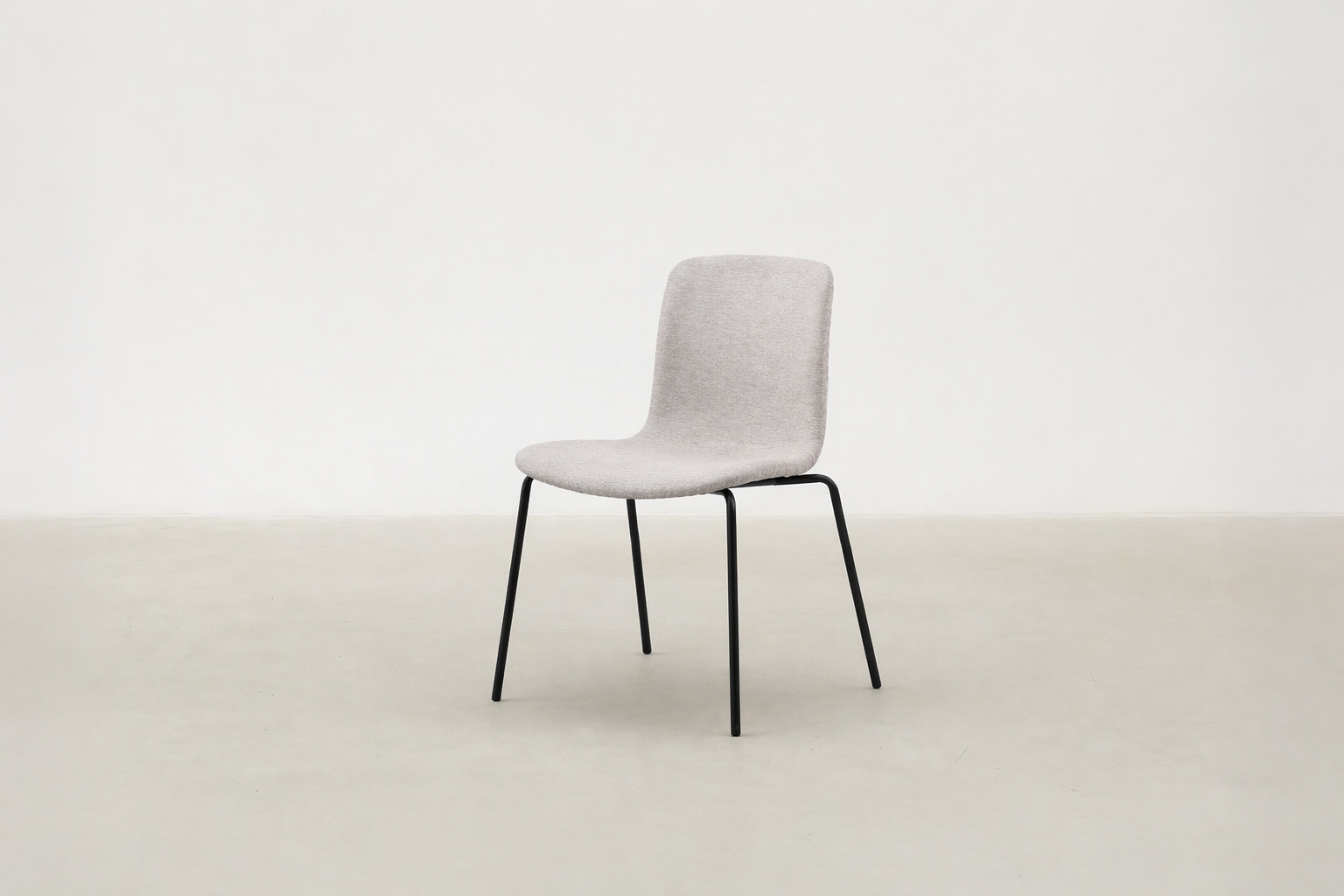 Minimalist dining chair with black metal legs and soft curved seat – Caprae chair for Canadian spaces