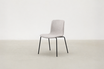 Minimalist dining chair with black metal legs and soft curved seat – Caprae chair for Canadian spaces