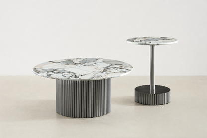 White round marble coffee table with veining and fluted black metal base – modern Canadian living room.