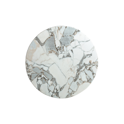 White round marble coffee table with veining and fluted black metal base – modern Canadian living room.