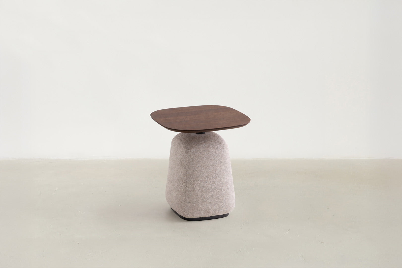 Esson end table with walnut veneer top and light grey upholstered base
