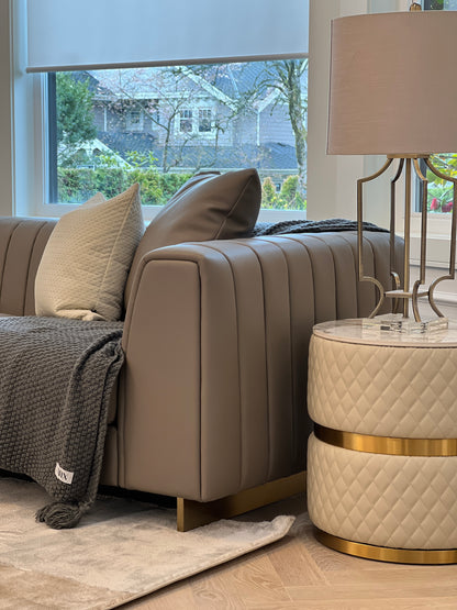Sassaste luxury round end table with faux-marble top, quilted PU leather base, and gold accent banding.