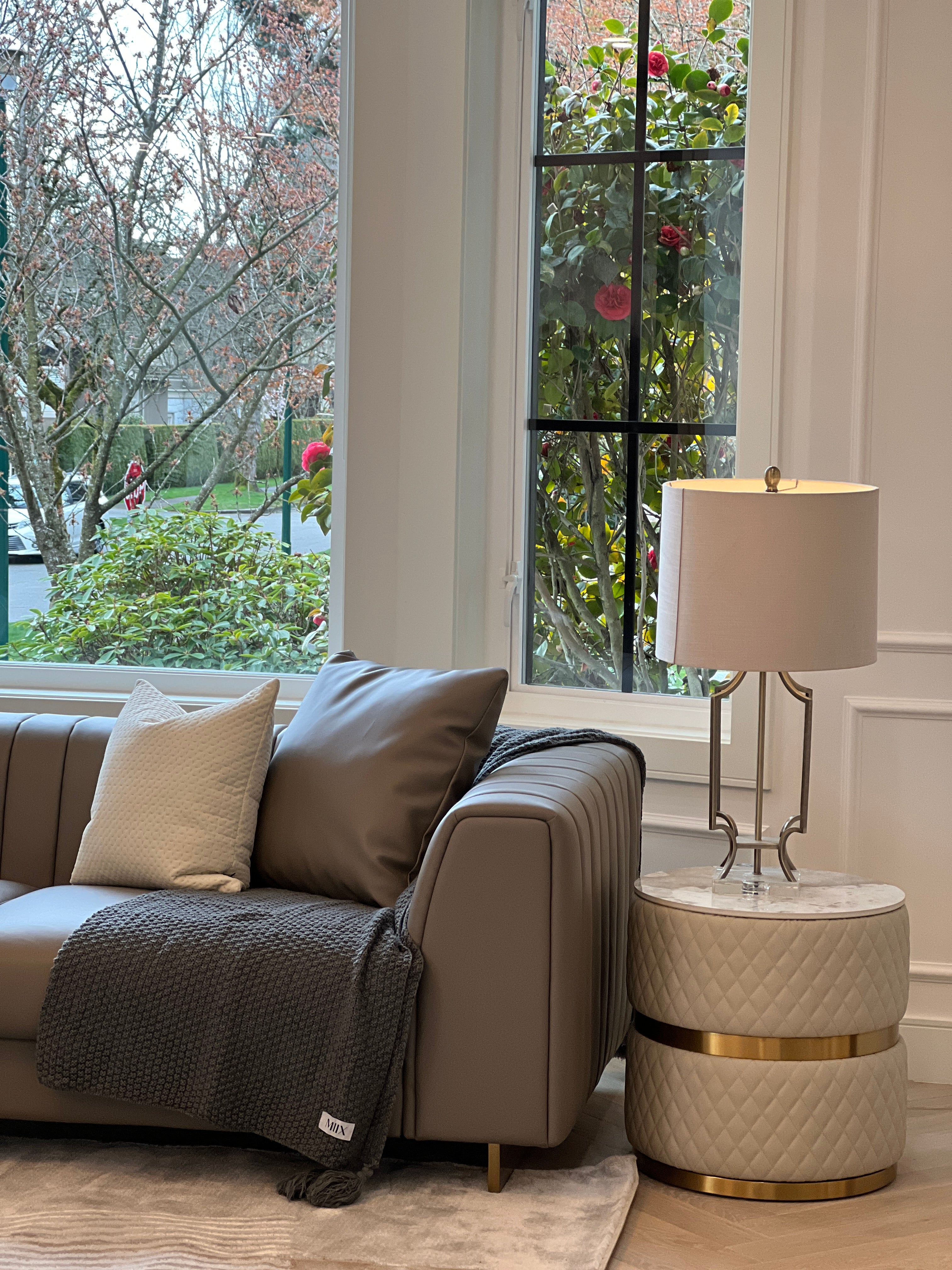 Sassaste luxury round end table with faux-marble top, quilted PU leather base, and gold accent banding.