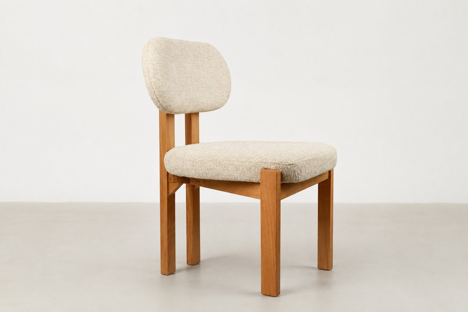 Sora Japandi dining chair with textured cream fabric and solid oak wood frame in natural stain