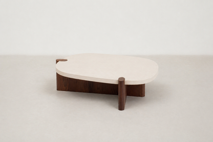 Nordli sculptural coffee table with walnut base and asymmetrical concrete-style top.