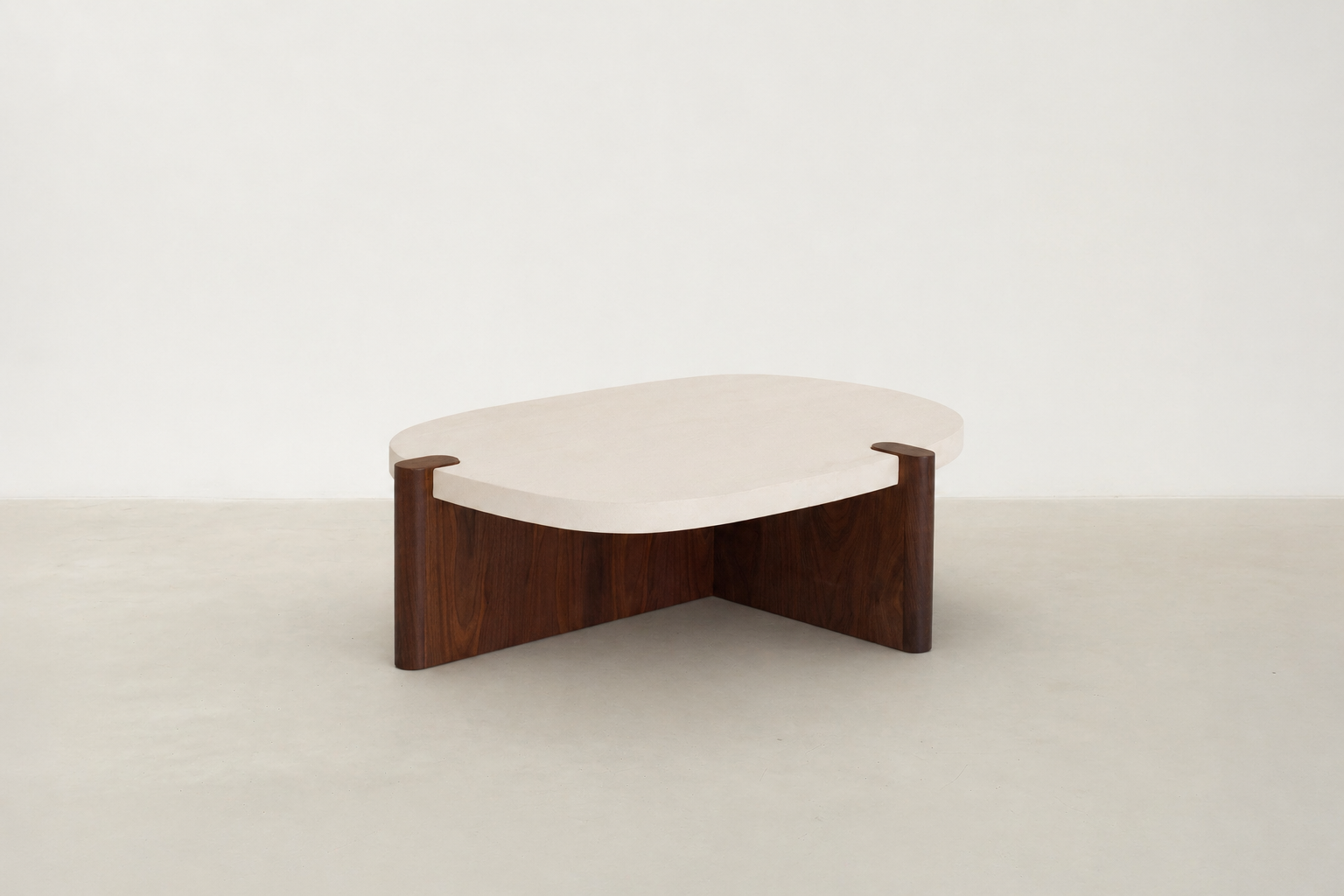 Nordli sculptural coffee table with walnut base and asymmetrical concrete-style top.