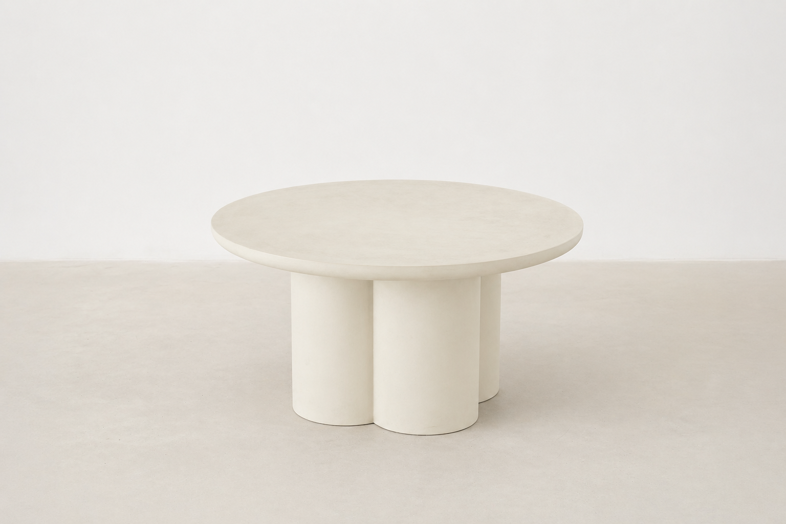 Pari Japandi coffee table with rounded silhouette and textured microcement finish