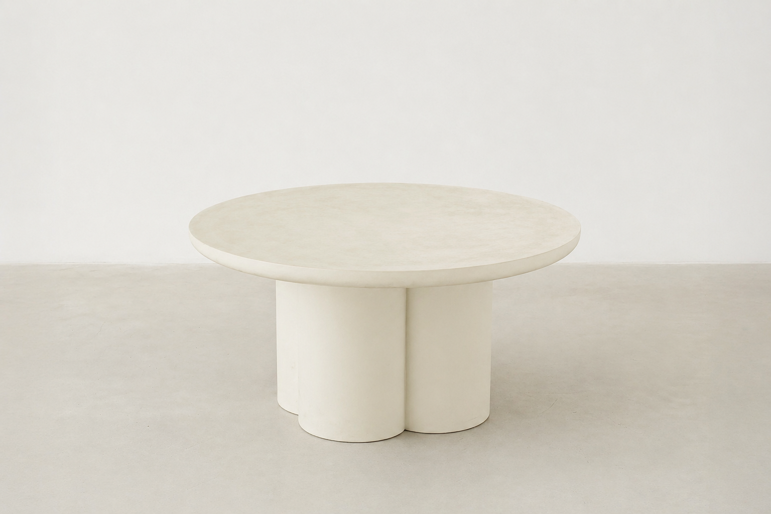Pari Japandi coffee table with rounded silhouette and textured microcement finish