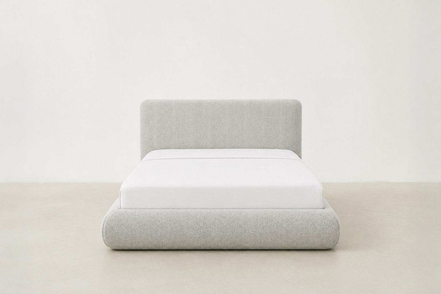 Sable light grey upholstered bed with rounded corners and low-profile design.