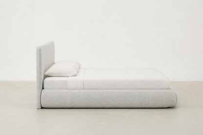Sable light grey upholstered bed with rounded corners and low-profile design.