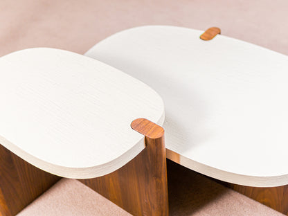 Nordli sculptural coffee table with walnut base and asymmetrical concrete-style top.
